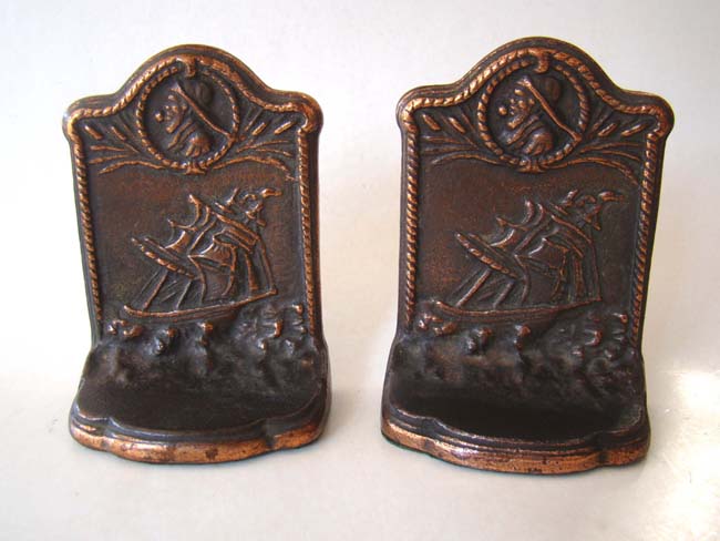 A pair of antique bookends featuring a sailing ship with a sailor's bust circa 1930